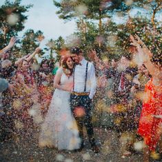 a bride and groom are surrounded by confetti