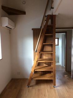 a wooden stair case in an empty room