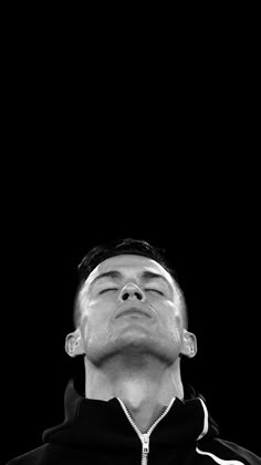 black and white photograph of a man with his eyes closed looking up at the sky