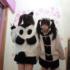 two girls dressed in costumes standing next to each other