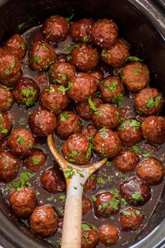 the meatballs are being cooked in the slow cooker