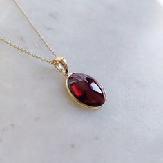 ITEM DESCRIPTION: >> The Pendant is made from Solid 14K Yellow Gold. Gemstone used is absolutely natural and ethically sourced. >> Natural Garnet in cabochon cut and oval shape with bezel setting is studded on it with utmost precision.  >> This is a minimalist design and is absolutely hassle-free and everyday jewelry.  Gem: Garnet Gem size: 12x14 mm oval Gem weight: 6.33 carats Gold purity: 14K (58.33% approx.) Gold weight: 0.49 grams  Gross weight: 1.76 grams The Gold purity is guaranteed and it comes with authentic 14K gold hallmark. Since this Pendant are handmade, It is Nickel/Lead FREE.  CUSTOMIZATION: --> Earrings of the same design can be made. --> You can choose your own gemstone. --> Kindly drop a message for the same. CUSTOMER SUPPORT: --> We are available 24/7 to respond to all Garnet Pendant Necklace, Garnet Necklace Gold, Red Garnet Jewelry, K Jewelry, Handmade Jewelry Box, Unique Pendant Necklace, Garnet Gem, Garnet And Gold, Garnet Pendant