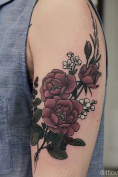 a woman with a flower tattoo on her arm