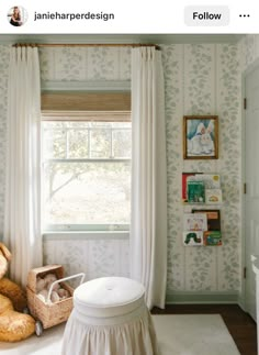 a teddy bear sitting in front of a window next to a stuffed animal on the floor