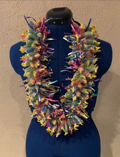 a mannequin wearing a multicolored necklace on it's back neck