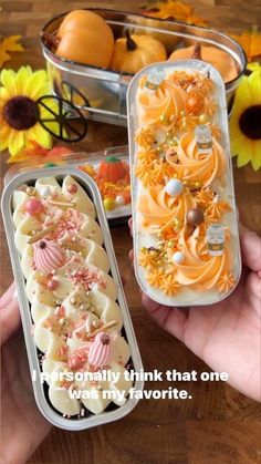 two plastic containers filled with food sitting on top of a wooden table next to sunflowers