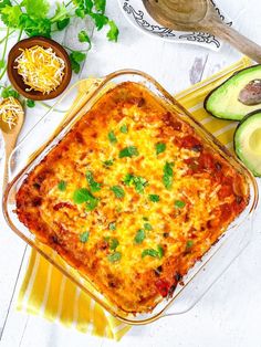 a casserole dish with cheese and vegetables on the side