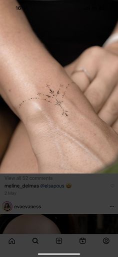 a woman's arm with a small tattoo on it