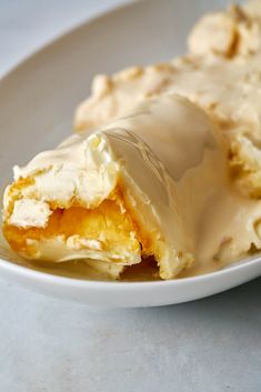 a white plate topped with pastry covered in icing