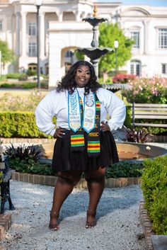 a woman standing in front of a building wearing a skirt and tie with words on it