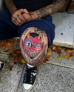 a man with tattoos on his leg and knee