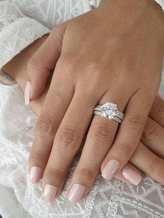 a close up of a person's hand with a wedding ring on their finger