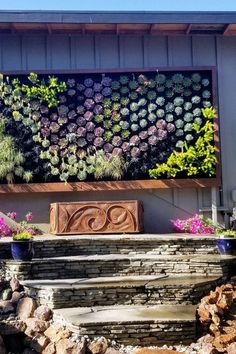 a stone bench sitting in front of a wall with plants growing on it's side