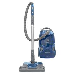 a blue vacuum is on the floor next to a cleaning bag and a duster