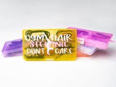 there are three plastic containers with hair clips in them on top of each other and the words gum hair stencils don't care