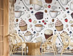 a wall with cupcakes and other desserts on it, along with two wicker chairs