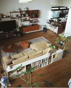 a living room filled with furniture and a flat screen tv on top of a wooden floor