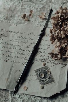 an old letter, pen and inkwell on a lace covered tablecloth with shells