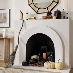 the fireplace is decorated with pumpkins and other decorative items, including a mirror above it