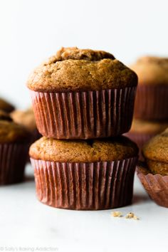 three chocolate muffins stacked on top of each other with text overlay that reads double chocolate muffins