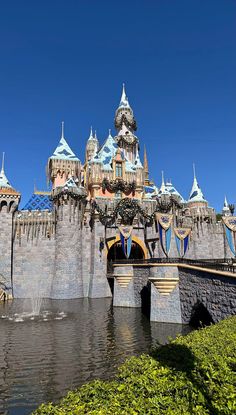 the entrance to disneyland's castle is shown in this photo from across the river