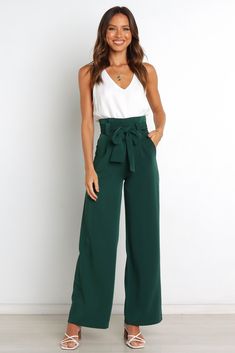 DETAILS    Step into timeless sophistication with our stylish Wide Leg Pant! The high-waisted design and gathered pleated waistband give you a flattering silhouette that's perfect for any occasion.   wide leg style pant  high waisted  gathered pleated waist band  front functional zip with hook and eye clasp  belt loops with detachable waist tie  functional pockets  lined   material - 97% polyester / 3% spandex    SIZING    model is 5' 6" and wears a Size 2  model stats: bust - 31.5", waist - 24.