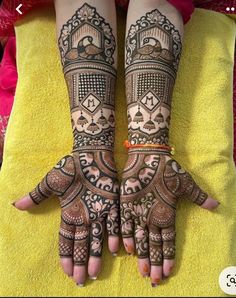 two hands with henna tattoos on them