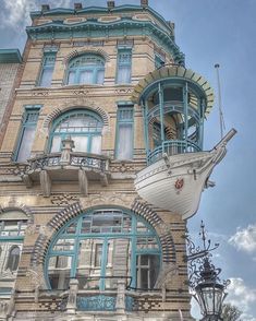 an old building with a large boat on the front and side of it's facade