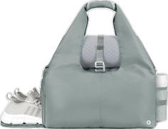 a grey bag with two shoes in front of it