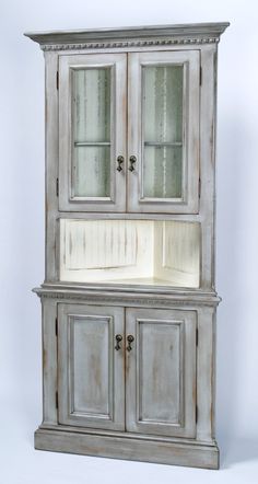 an old white cabinet with glass doors on the top and bottom, against a white background