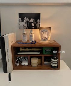 a shelf with some books and other items on it next to a light that is turned on