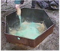 a person pouring water into a metal container