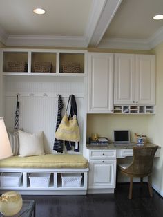 a living room filled with furniture and white cabinets