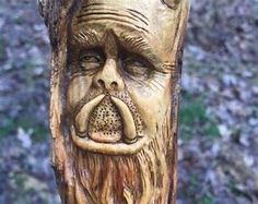 a carved tree with a man's face on it