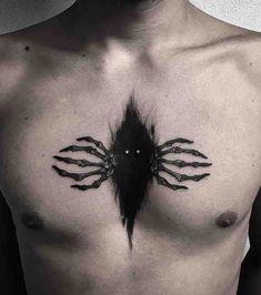 a man's chest is covered in black ink and has claws on his chest