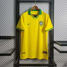 a yellow soccer jersey hanging on a rack