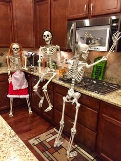 two skeletons standing in the kitchen next to each other