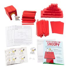 an assortment of red crafting supplies including paper, scissors and stickers to make snoopy