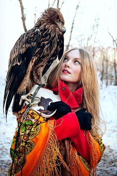 a woman with an eagle on her shoulder