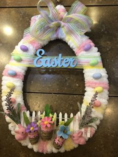 a wreath with easter decorations hanging on the wall