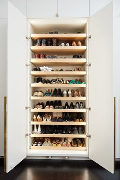 the closet is filled with many pairs of shoes