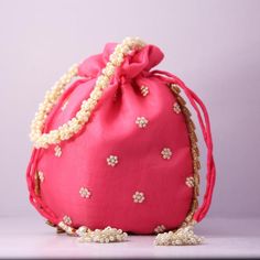 Material:Organza, PearlColor: Carat PinkPackage Contents: As per quantity purchasedSize: 22 cm x 22 cm x 5 cmDesigned with the heart, this beautiful Potli or batawa bag are eye catchy and made of premium material.Key Features:Embroidery art workThis potli is good match with both Indian and western outfits and are superb for wedding and festive partiesThis would be best complement to your designer saree, lenhga or any other kind of dressThis is the combination of traditional and modern embroidery Pink Pouch Evening Bag For Wedding, Traditional Pink Shoulder Bag For Evening, Elegant Pink Shoulder Bag For Festivals, Formal Potli Gift Bag For Festivals, Elegant Red Potli Bag For Wedding, Handmade Handheld Potli Bag For Celebration, Traditional Red Shoulder Bag For Wedding, Festive Pink Handcrafted Shoulder Bag, Pink Rectangular Shoulder Bag For Wedding