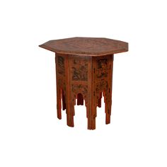 an octagonal wooden table with carvings on it