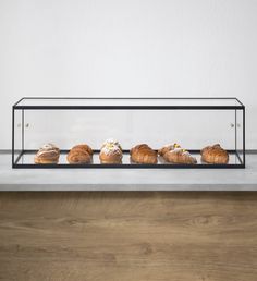 a display case filled with lots of different types of pastries on top of a counter