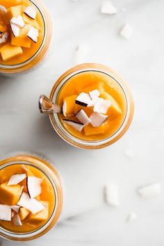 two glass jars filled with food sitting on top of a white counter next to each other