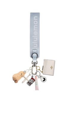 a key chain with an animal, book and other items attached to the lanyard