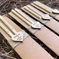 six personalized candles are wrapped in brown paper