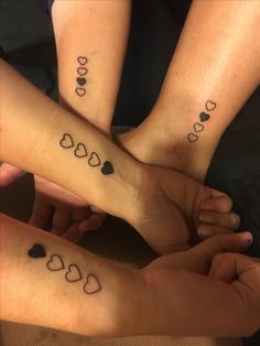 three people with matching tattoos on their feet