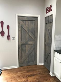 two wooden doors in a kitchen with white cabinets