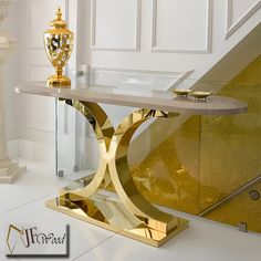 a modern console table in gold and white